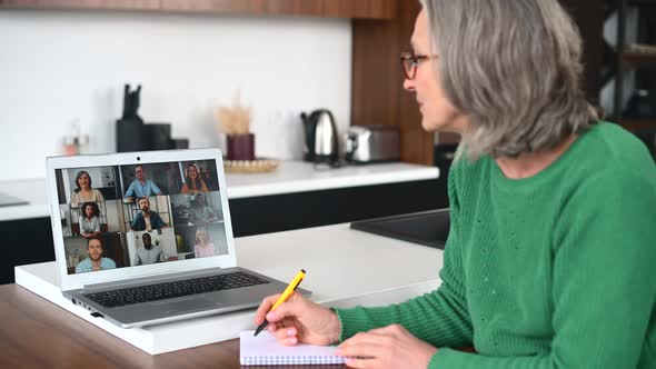 Mature Senior Woman is Using a Laptop for Video Call at Home