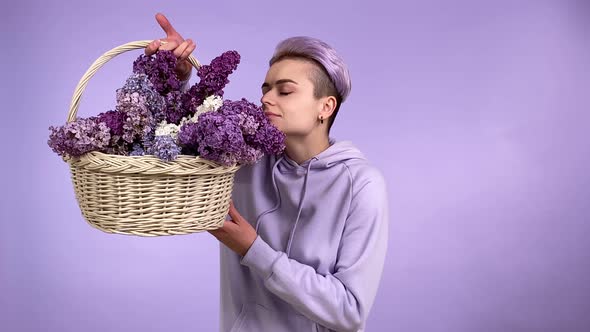 Young Woman Holding Wicker Busket Smelling Lilac Bouquet Isolated