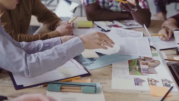 Close-up View of Multiethnic Group of People Working at the Table. Creative Business Team Choose the