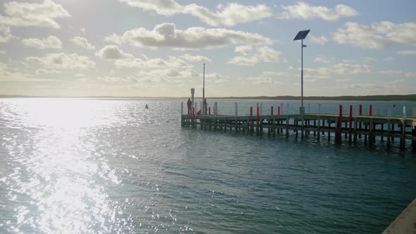 People fishing off the edge of Inverloch jetty in Australia.