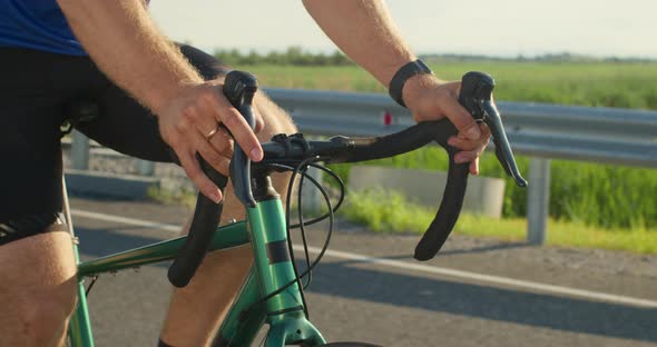 Closeup of a Bicyclist's Hands on the Steering Wheel