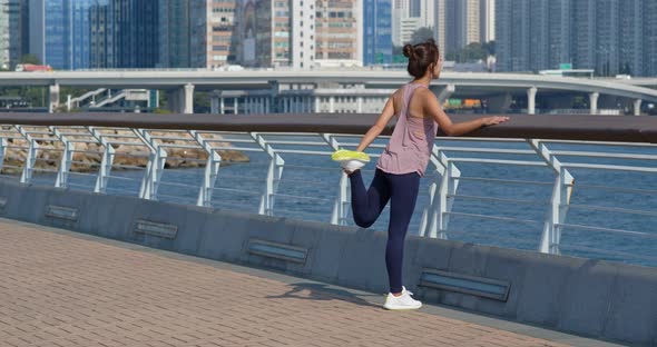 Woman stretch legs before running at outdoor