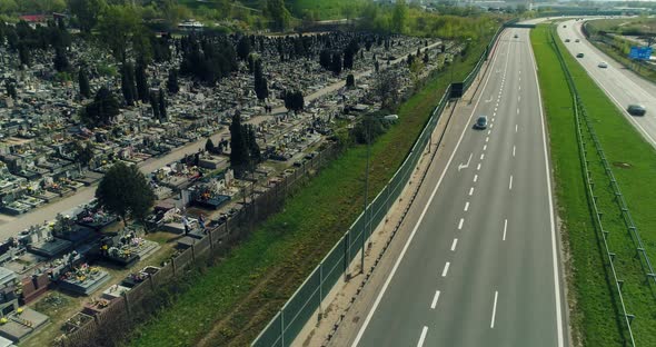 Aerial view of a cemetery by multiple lane highway.