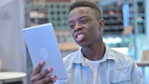 African Man Doing Video Chat on Tablet