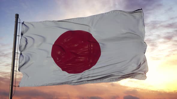 Flag of Japan Waving in the Wind Against Deep Beautiful Sky at Sunset