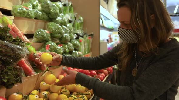 Woman Checking Fruits in Grocery Wearing Mask