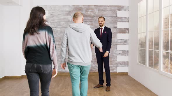Real Estate Agent Shows New Apartment To Young Couple