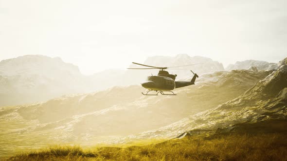 Slow Motion Vietnam War Era Helicopter in Mountains