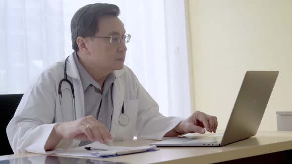 Doctor Working with Patient Health Data in the Hospital Office