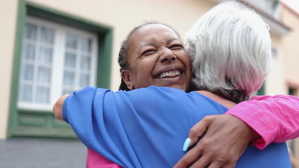 Multiracial Senior Women Hugging Each Other Elderly Friendship and Love Concept Focus on African