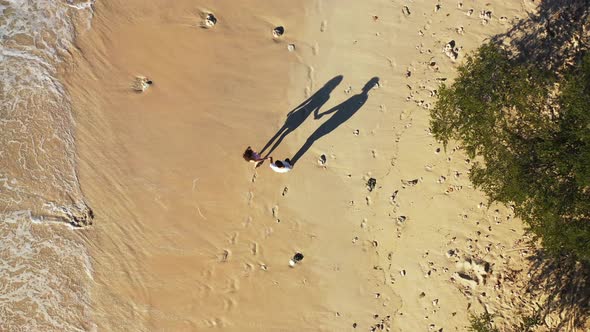 Fun man and woman on honeymoon vacation have fun on beach on white sand background 4K