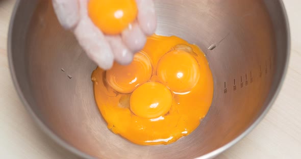 4K - Cook puts egg yolks in a bowl