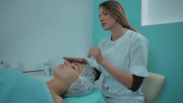 Closeup of a Girl Doing a Cosmetic Procedure Facial Massage