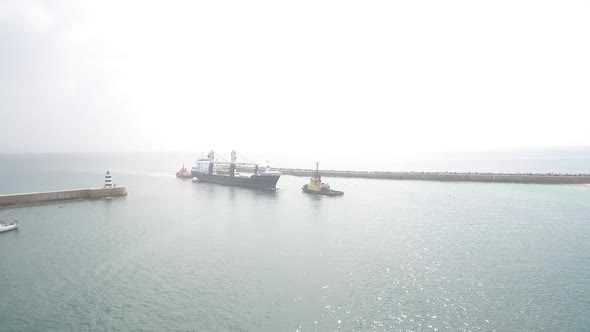 Cargo ship being towed