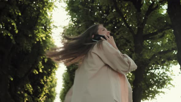Woman Phone Calling in Tree Alley