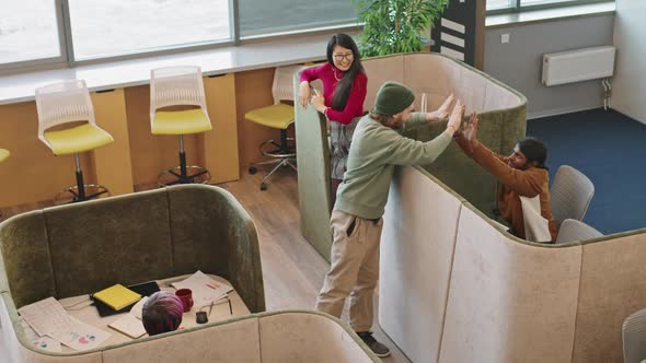 Happy Man High-Fiving Colleagues