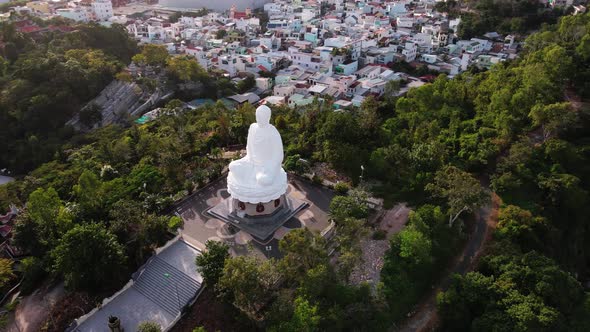 Aerial View Flying Around the Huge Big Buddha Statue in Vietnamagainst the Backdrop of Green Palms