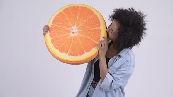 Young Happy African Woman with Orange Pillow As Healthy Concept