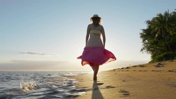 Slow Motion Woman Walking Barefoot By Beach at Golden Sunset Footprints in Sand