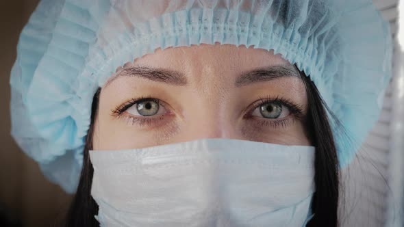 Tired Look of a Health Worker Wearing a Surgical Mask During a Break