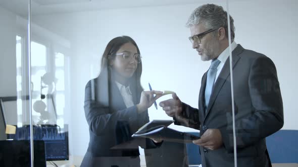 Business Leader and His Assistant Writing and Sticking Notes