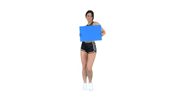 Charming girl holding empty board and dancing on white background.