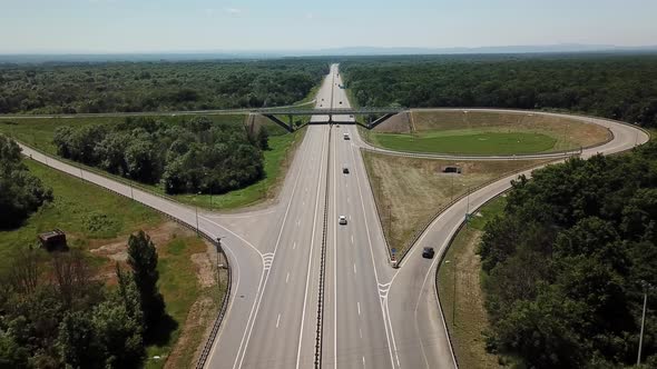 Aerial View of Highway Road Junction in the Countryside with Trees and Cultivated Fields