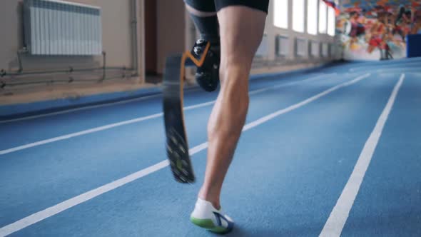 A Man Jogging on a Track with Prosthetic Leg