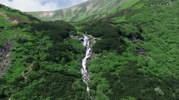 Aerial View Of A Plateau Waterfall Majestic High Mountain Range Surrounding