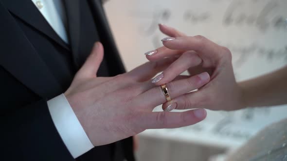 Bride and Groom Exchanging Wedding Ring in Ceremony