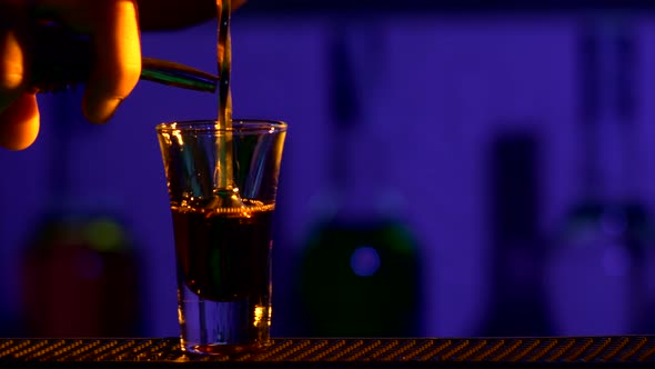 Bartender Is Making Cocktail and Adding Ingredient at Bar Counter, Close Up, Shots, Dark Light