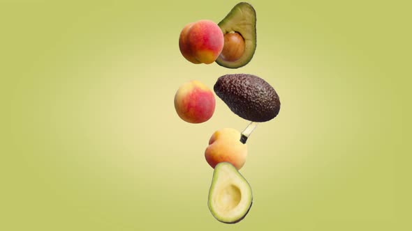 Avocados and Peaches Falling on a Colored Background