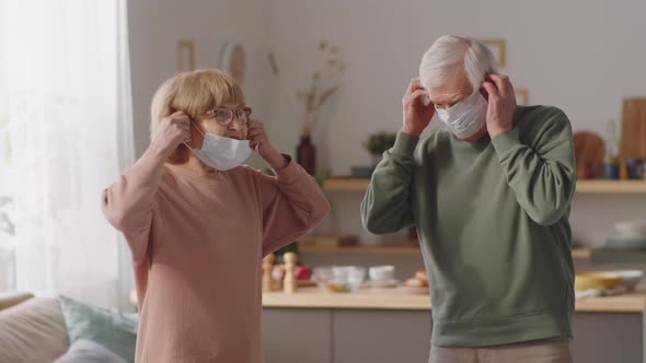 Elderly Couple Putting On Masks before Leaving Home
