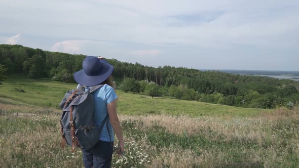 Woman Travels With a Backpack in Beautiful Places