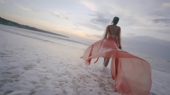 Back View of Beautiful Fashionable Woman on Empty Beach By Sea