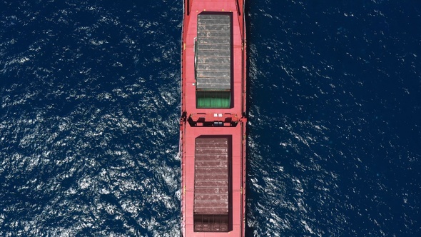 Large cargo ship carrying containers in the sea- Aerial