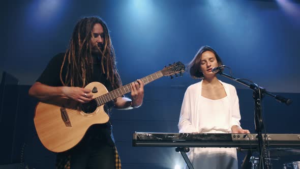 Female Singer and Musician Performing on Stage