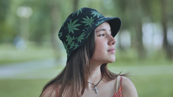 Portrait of a Teenage Girl in a Panama Hat in a Park in the Summer