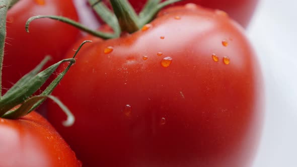 Delicious red  wet tomato on the white surface 4K 2160p 30fps UltraHD  slow tilt footage - Water dro