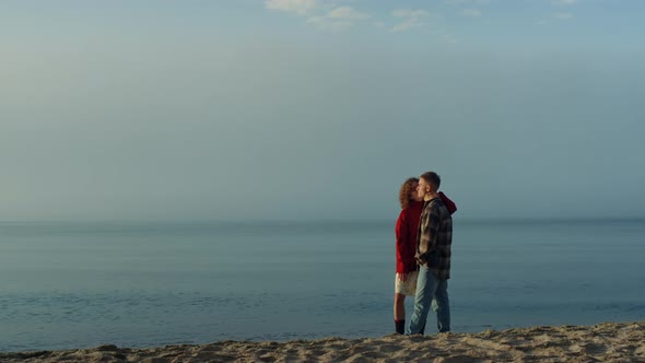 Affectionate Couple Standing on Sea Shore