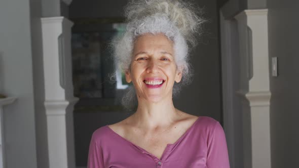 Portrait of caucasian senior woman smiling at home