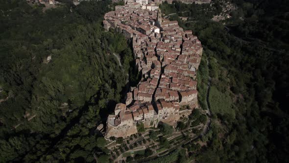 -SHOT: previous zenith-DESCRIPTION: drone video over the side of Pitigliano, Italy-HOUR.WEATHER: s