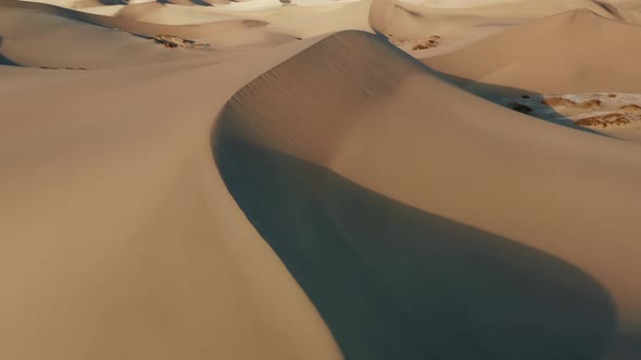 Cinematic View of High Sand Dunes in Sunset Light Deep Shadows From Sand Peaks