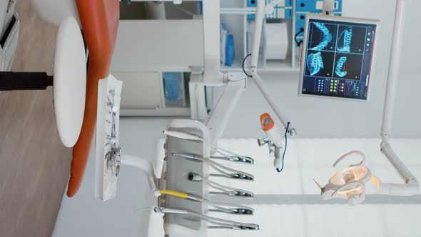 Vertical Video Interior of Modern Equipment Oral Office with Teeth x Ray on Monitors