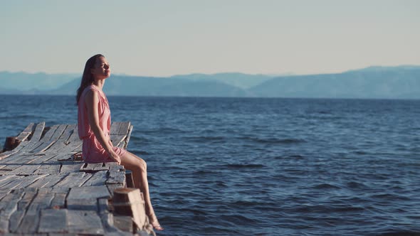 Young attractive girl on a pier