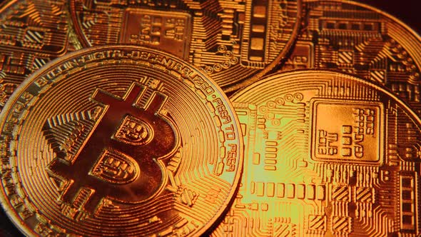 Close-up of Bitcoin cryptocurrency coins with beautiful glare of orange light running across them