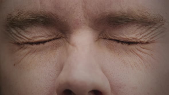 Closeup Caucasian Man Opening His Blue Eyes in Slow Motion