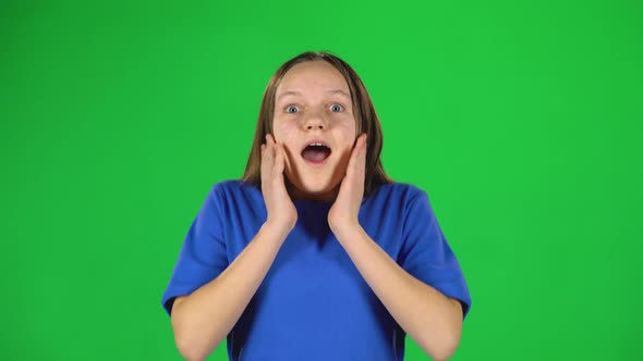 Girl Is Surprised and Very Rejoiced in Studio on Green Screen