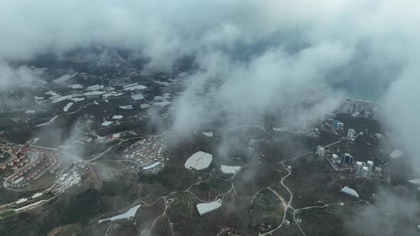 Over the city in the clouds aerial view 4 K