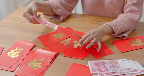 Woman fill money with red pocket